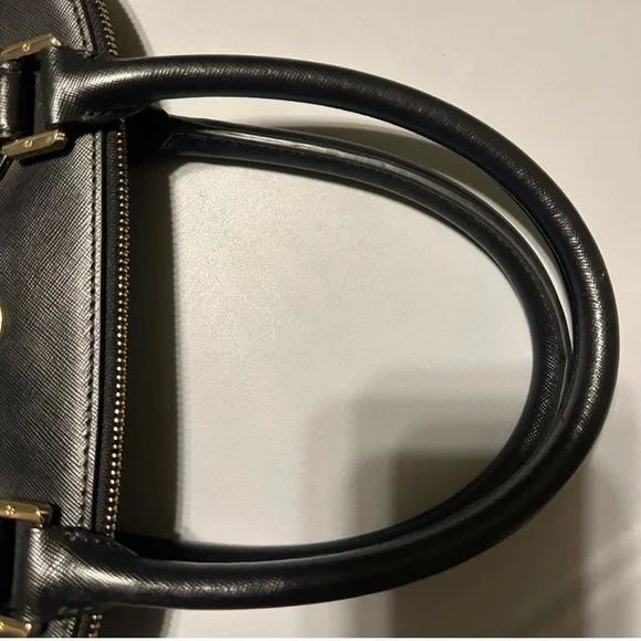 Tory Burch used handbag. About 15” wide and 13 “ tall. This bag is not new.